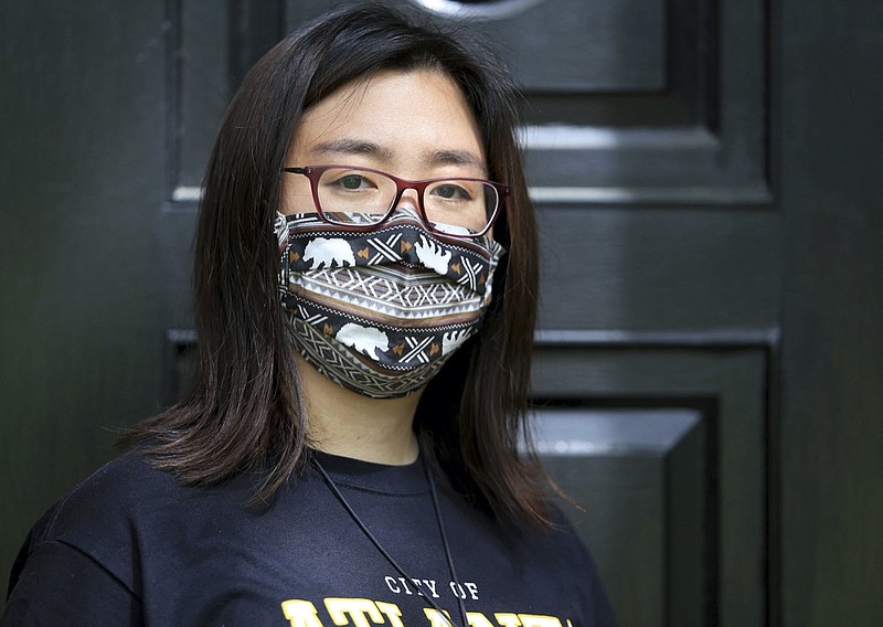 Claire Xu, poses for a photo, Friday, April 9, 2021, in Decatur, Ga., Xu was propelled into action following the mass fatal shootings of eight people, six of them Asian women, at a Georgia massage businesses in March. She organized a massive rally condemning violence against Asian Americans that drew support from a broad group of activists, elected officials and community members. But her own parents were opposed. "'We don't want you to do this,'" Xu, 31, recalled their telling her afterward. "'You can write about stuff, but don't get your face out there.'" (AP Photo/Akili-Casundria Ramsess)