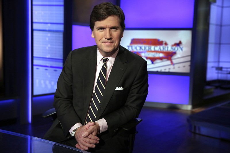 AP file photo by Richard Drew / In this Thursday, March 2, 2107 file photo, Tucker Carlson, host of "Tucker Carlson Tonight," poses for a photo in a Fox News Channel studio in New York. The Anti-Defamation League has called for Fox News to fire prime-time opinion host Tucker Carlson because he defended a white-supremacist theory that says whites are being "replaced" by people of color.