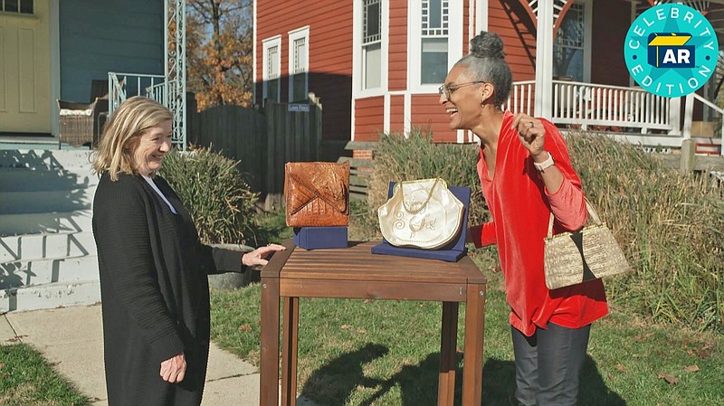 This image released by WGBH-TV shows Katy Kane, left, as she appraises celebrity chef Carla Hall's vintage purse collection in an episode of "Antiques Roadshow Celebrity Edition," airing May 10 on PBS. (WGBH/PBS via AP)
