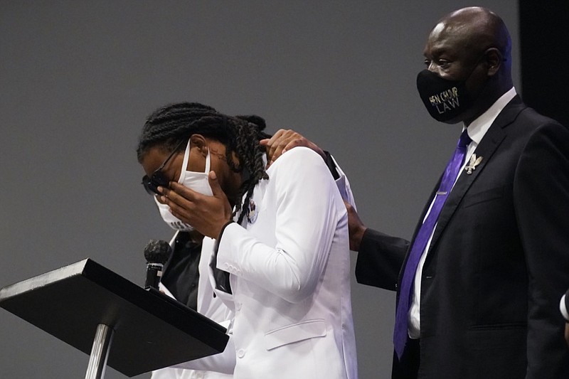 Andrew Brown Jr.'s son Khalil Ferebee, speaks during the funeral for his father Brown Jr., Monday, May 3, 2021, at Fountain of Life Church in Elizabeth City, N.C. Brown was fatally shot by Pasquotank County Sheriff deputies trying to serve a search warrant. Attorney Ben Crump, is seen at right. (AP Photo/Gerry Broome)