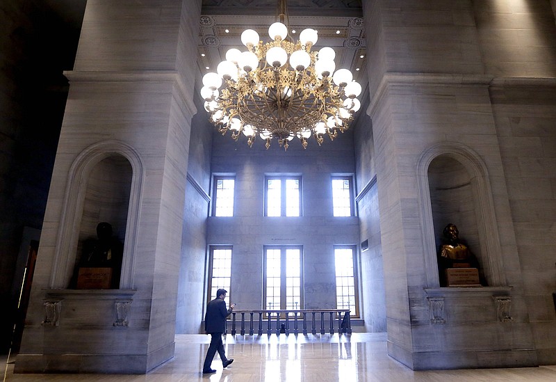 AP file photo by Mark Humphrey / A man walks through the hall outside the House and Senate chambers in Nashville.