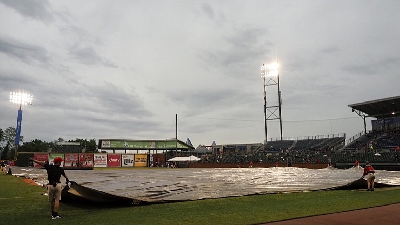 Staff photo by C.B. Schmelter / Members of the grounds crew cover the infield on opening day at AT&T Field on Tuesday, May 4, 2021 in Chattanooga, Tenn. The Chattanooga Lookouts were slated to open their season against the Rocket City Trash Pandas, however, inclement weather forced the game to be postponed.