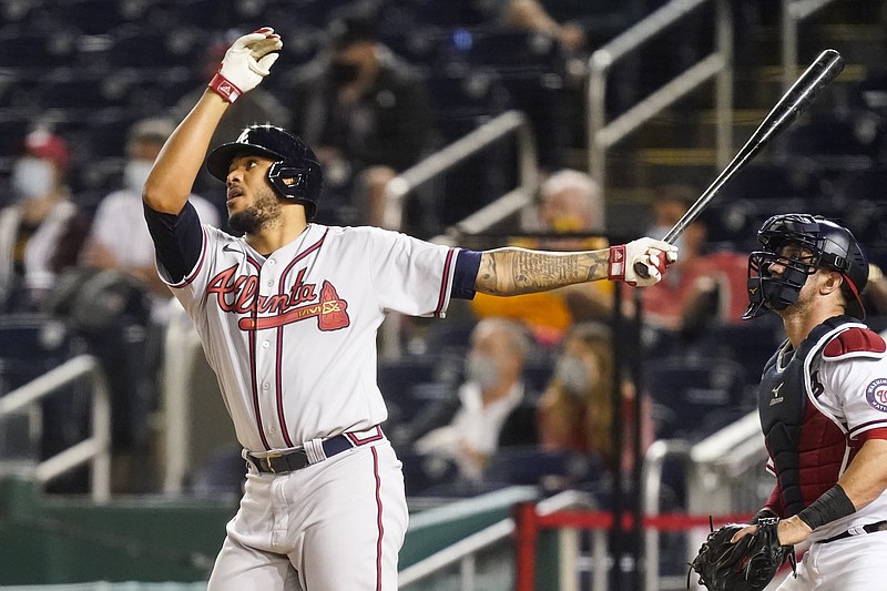 Atlanta Braves' Huascar Ynoa watches his grand slam during the sixth inning of baseball game against the Washington Nationals at Nationals Park, Tuesday, May 4, 2021, in Washington. (AP Photo/Alex Brandon)