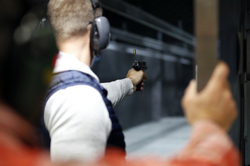 Chicago resident Ray Mandel practices shooting during a session at Maxon Shooter's Supplies and Indoor Range, Friday, April 30, 2021, in Des Plaines, Ill. After a year of pandemic lockdowns, mass shootings are back, but the guns never went away. As the U.S. inches toward a post-pandemic future, guns are arguably more present in the American psyche and more deeply embedded in American discourse than ever before. The past year's anxiety and loss fueled a rise in gun ownership across political and socio-economic lines. (AP Photo/Shafkat Anowar)