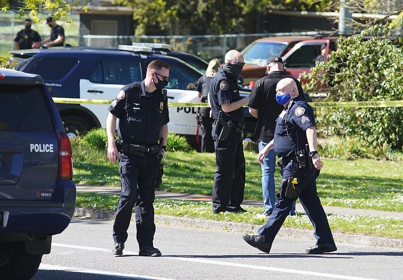 FILE - In this Friday, April 16, 2021, file photo, law enforcement personnel work at the scene following a police-involved shooting of a man at Lents Park, in Portland, Ore. Police fatally shot a man in the city park Friday, April 30, 2021 after responding to reports of a person with a gun. Unlike shootings involving police around the country there was no body camera footage of this encounter. Portland, which has become the epicenter of racial justice protests, is one of the few major U.S. cities where police do not have body cameras. (Beth Nakamura/The Oregonian via AP, File)