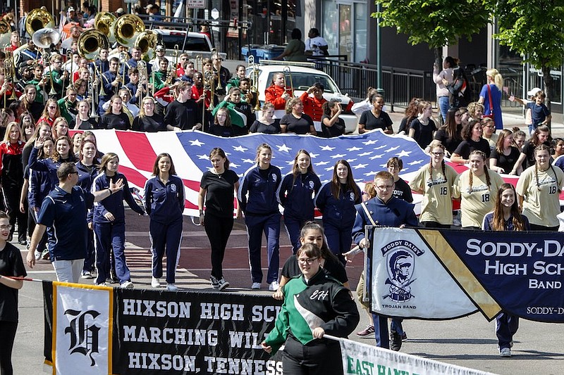 Staff photo by C.B. Schmelter / Members from various local high school marching bands carry an American flag during the 70th annual Armed Forces Day Parade on Friday, May 3, 2019, in Chattanooga, Tenn.