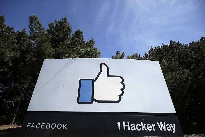 FILE - In this April 14, 2020 file photo, the thumbs up Like logo is shown on a sign at Facebook headquarters in Menlo Park, Calif. Facebook's oversight board, which on Wednesday, May 5, 2021 upheld the company's ban of former President Donald Trump, also had some harsh words for its corporate sponsor: Facebook. But critics aren't convinced this decision is a triumph of accountability, and say its actions may actually distract from more fundamental issues that Facebook seems less interested in talking about. (AP Photo/Jeff Chiu, File)