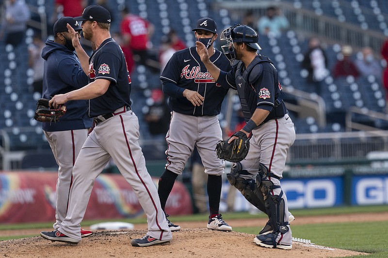 AP photo by Manuel Balce Ceneta / Atlanta Braves catcher Jeff Mathis, right, celebrates with his teammates after they beat the host Washington Nationals 3-2 on Thursday to complete a three-game sweep.