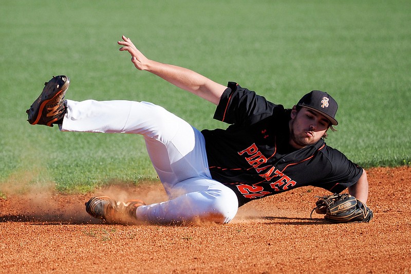 Staff photo by C.B. Schmelter / South Pittsburg's Javen Talley loses his footing while stopping a ball during the District 5-A championship game against visiting Van Buren County on Thursday.