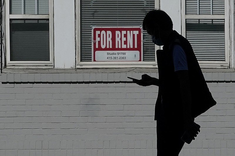 FILE - In this Oct. 20, 2020 file photo, a man walks in front of a For Rent sign in a window of a residential property in San Francisco. The Biden administration on Friday, May 7, 2021, announced the allocation of $21.6 billion to provide emergency rental assistance to help prevent evictions of people who lost jobs during the pandemic. (AP Photo/Jeff Chiu, File)