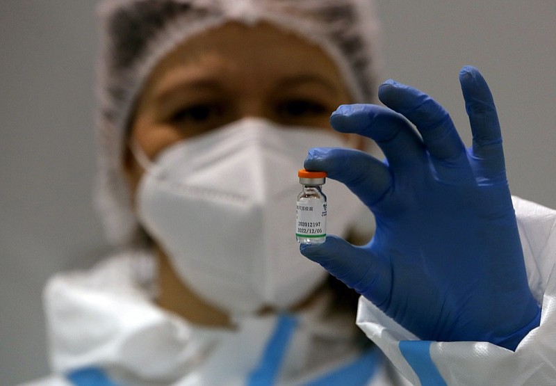 FILE - In this Tuesday, Jan. 19, 2021 file photo, a medical worker poses with a vial of the Sinopharm's COVID-19 vaccine in Belgrade, Serbia. (AP Photo/Darko Vojinovic, file)


