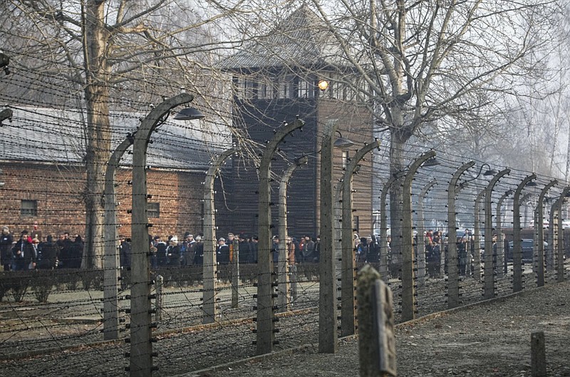 FILE- In this file photo taken Jan. 27, 2020, people are seen arriving at the site of the Auschwitz-Birkenau Nazi German death camp, where more than 1.1 million were murdered, in Oswiecim, Poland, for observances marking 75 years since the camp's liberation by the Soviet army. (AP Photo/Czarek Sokolowski, FIle)


