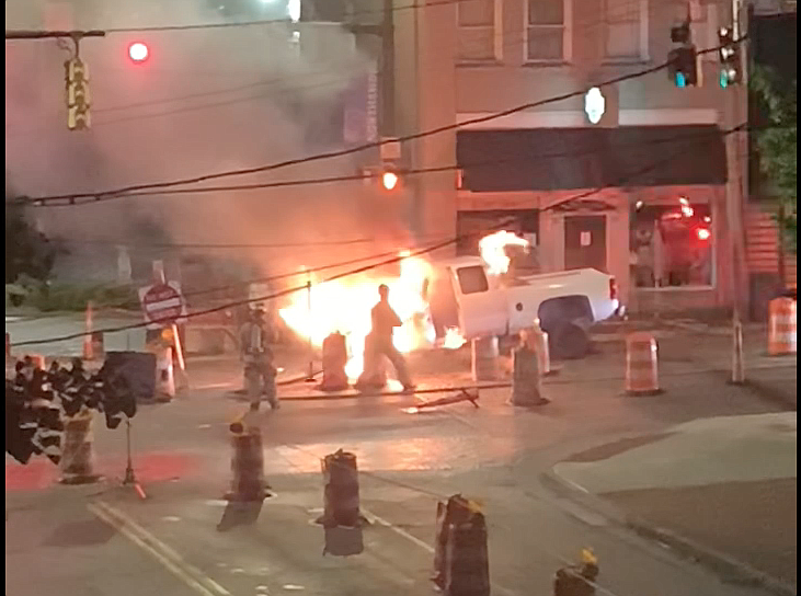 A truck caught fire late Thursday night, May 6, 2021, after the driver ran off the road into a trench in the construction zone near the intersection of Frazier Avenue and Tremont Street on Chattanooga's North Shore. (Screenshot taken from contributed video)