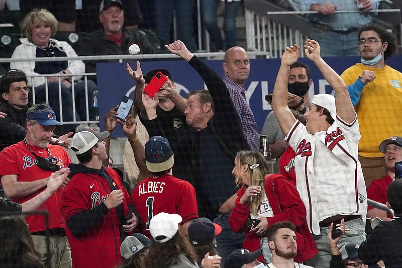 AP photo by John Bazemore / Fans reach for a foul ball during Friday's game between the Philadelphia Phillies and the host Atlanta Braves.