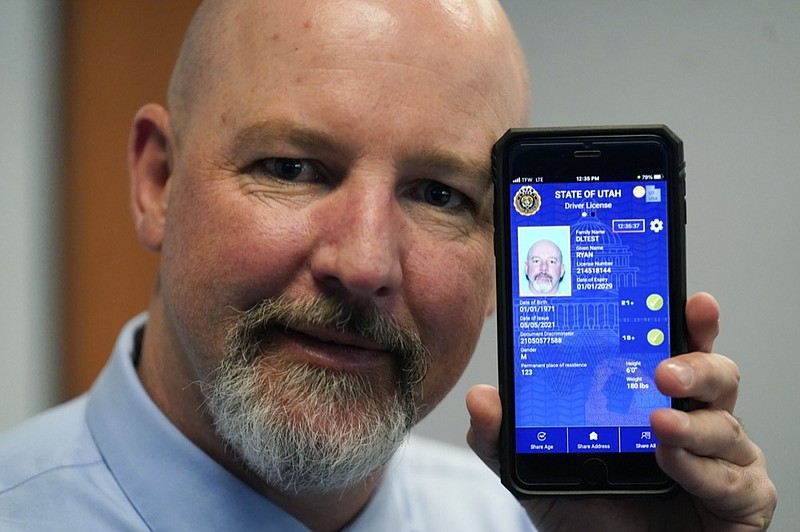 Ryan Williams, with the Utah Drivers License Division, displayes his cell phone with the pilot version of the state's mobile ID on Wednesday, May 5, 2021, in West Valley City, Utah. (AP Photo/Rick Bowmer)


