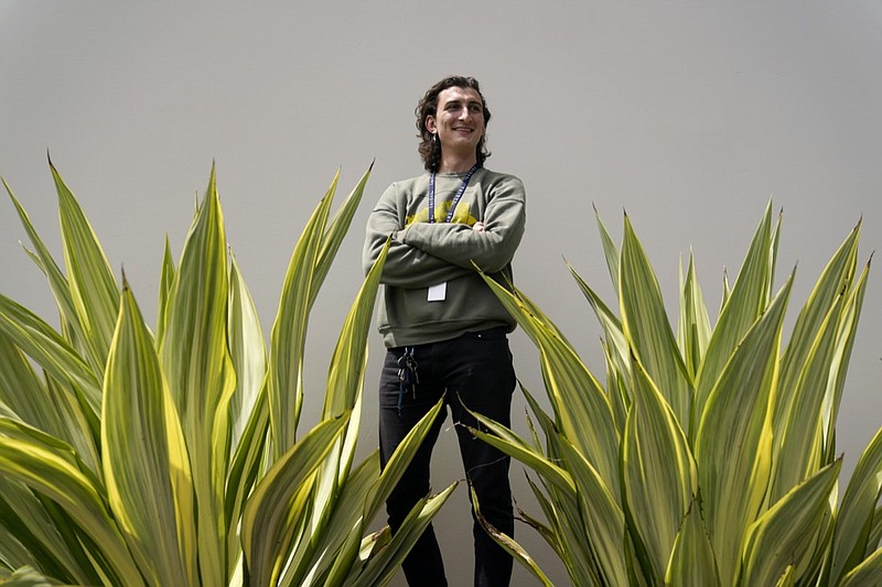 Lucius Giannini stands for a portrait Thursday, April 15, 2021, in San Diego. Giannini graduated from the University of California at San Diego at the end of last summer with a degree in political science. He had hoped to find work with the Peace Corps, or maybe teaching English overseas. But the Peace Corps was bringing all its volunteers home, and no one was hiring for overseas teaching. (AP Photo/Gregory Bull)

