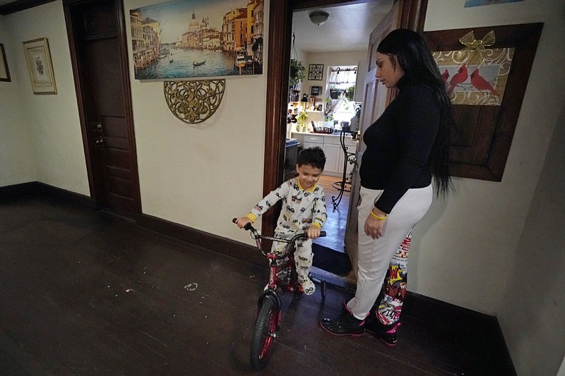 FILE - In this March 10, 2021, file photo, Isabel Miranda's 4-year-old son, Julian, rides his bike into the hallway of their rental apartment in Haverhill, Mass. A federal judge has ruled, Wednesday, May 5, 2021, that the Centers for Disease Control exceeded its authority when it imposed a federal eviction moratorium to provide protection for renters out of concern that having families lose their homes and move into shelters or share crowded conditions with relatives or friends during the pandemic would further spread the highly contagious virus. Miranda and her family would no longer have this eviction protection if this ruling stands. (AP Photo/Elise Amendola, File)