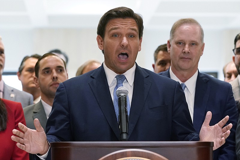 Photo by Wilfredo Lee of The Associated Press / Surrounded by lawmakers, Florida Gov.Ron DeSantis speaks at the end of a legislative session, Friday, on April 30, 2021, at the Capitol in Tallahassee, Florida.
