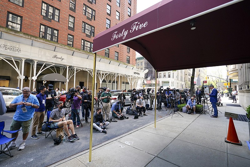 Photo by Mary Altaffer of The Associated Press / Journalists assemble outside the apartment building where former New York Mayor Rudy Giuliani lives on Wednesday, April 28, 2021, in New York. Federal agents raided Giuliani's Manhattan home and office, seizing computers and cell phones in a major escalation of the Justice Department's investigation into the business dealings of former President Donald Trump's personal lawyer.