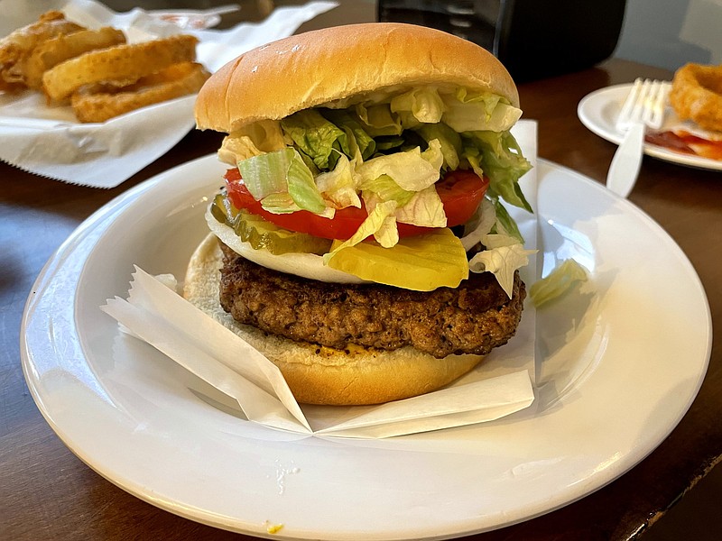 Photo by Anne Braly / The half-pound burger at Rallo's stacks up nicely with its mound of toppings and a seasoned meat patty.