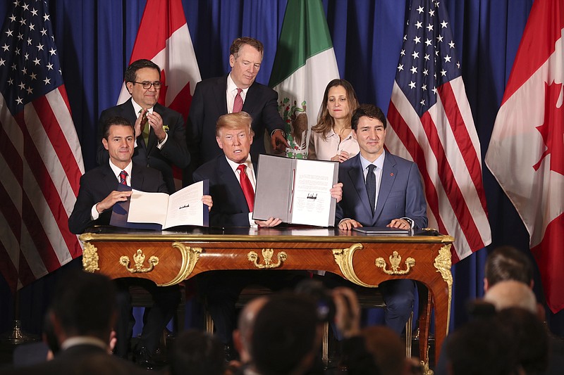 FILE - In this Nov. 30, 2018 file photo, President Donald Trump, center, sits between Canada's Prime Minister Justin Trudeau, right, and Mexico's President Enrique Pena Nieto after they signed a new United States-Mexico-Canada Agreement that is replacing the NAFTA trade deal, during a ceremony at a hotel before the start of the G20 summit in Buenos Aires, Argentina. U.S. and Mexican unions have filed on Monday, May 10, 2021, the first labor complaint against Mexico under the U.S.-Mexico-Canada free trade pact. (AP Photo/Martin Mejia, file)