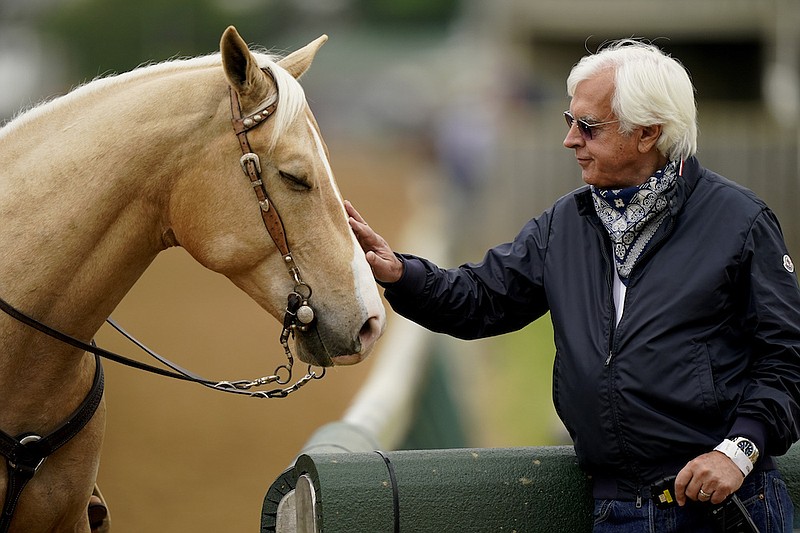 Trainer Bob Baffert pets an outrider's horse while watching workouts at Churchill Downs Wednesday, April 28, 2021, in Louisville, Ky. The 147th running of the Kentucky Derby is scheduled for Saturday, May 1. (AP Photo/Charlie Riedel)