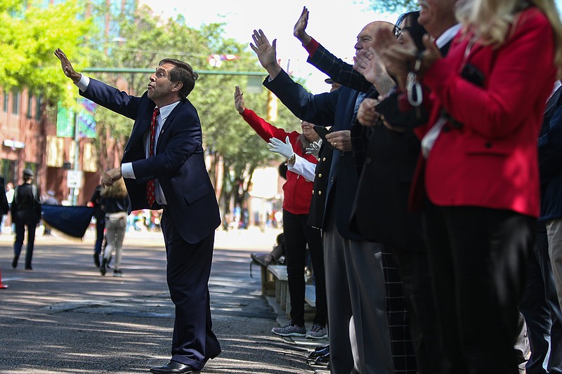 Staff photo by Troy Stolt / U.S. Rep. Chuck Fleischmann waves at paraders from in front of the Hamilton County Courts Building during the 72nd annual Armed Forces Day parade in downtown Chattanooga, Tennessee, on Friday, May 7, 2021.