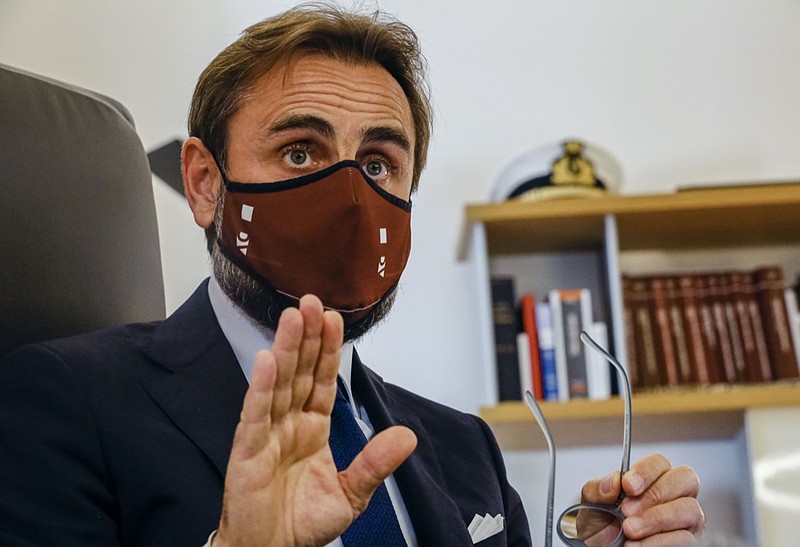 Lawyer Roberto De Vita, representing WHO's deputy director General Ranieri Guerra, speaks during an interview with The Associated Press at his law firm in Rome, Monday, May 10, 2021. A top World Health Organization official has strongly denied making false statements to Italian prosecutors about a spiked U.N. report into Italy's coronavirus response, doubling down on his assertions in court documents obtained by The Associated Press. Dr. Ranieri Guerra, a WHO special adviser, outlined his position in a 40-page response, with a 495-page annex, to prosecutors who placed him under investigation last month for having allegedly made false statements to them when he voluntarily went to be questioned Nov. 5. (AP Photo/Domenico Stinellis)
