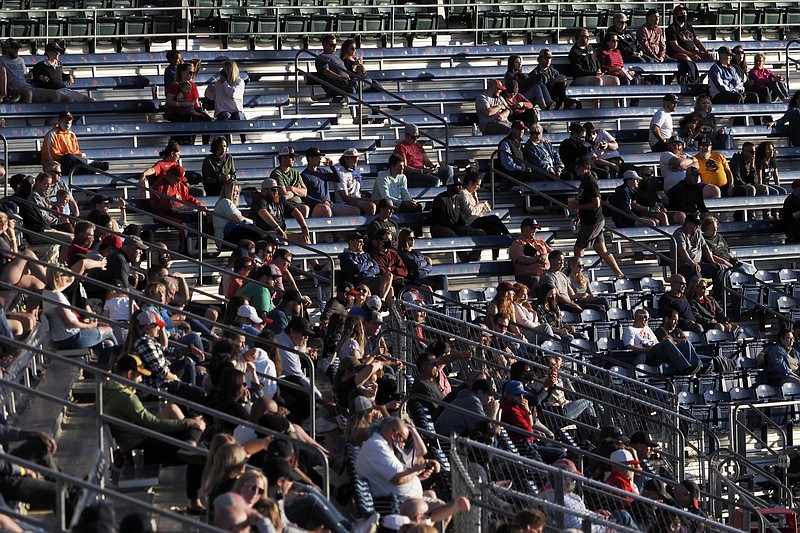 Staff photo by C.B. Schmelter / Socially distanced Chattanooga Lookouts fans take in the team's opening win over the Rocket City Trash Pandas on May 5 at AT&T Field.