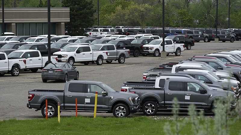 Ford pickup trucks built lacking computer chips are shown in parking lot storage in Dearborn, Mich., Tuesday, May 4, 2021. Automakers are cutting production as they grapple with a global shortage of computer chips, and that's making dealers nervous. (AP Photo/Paul Sancya)