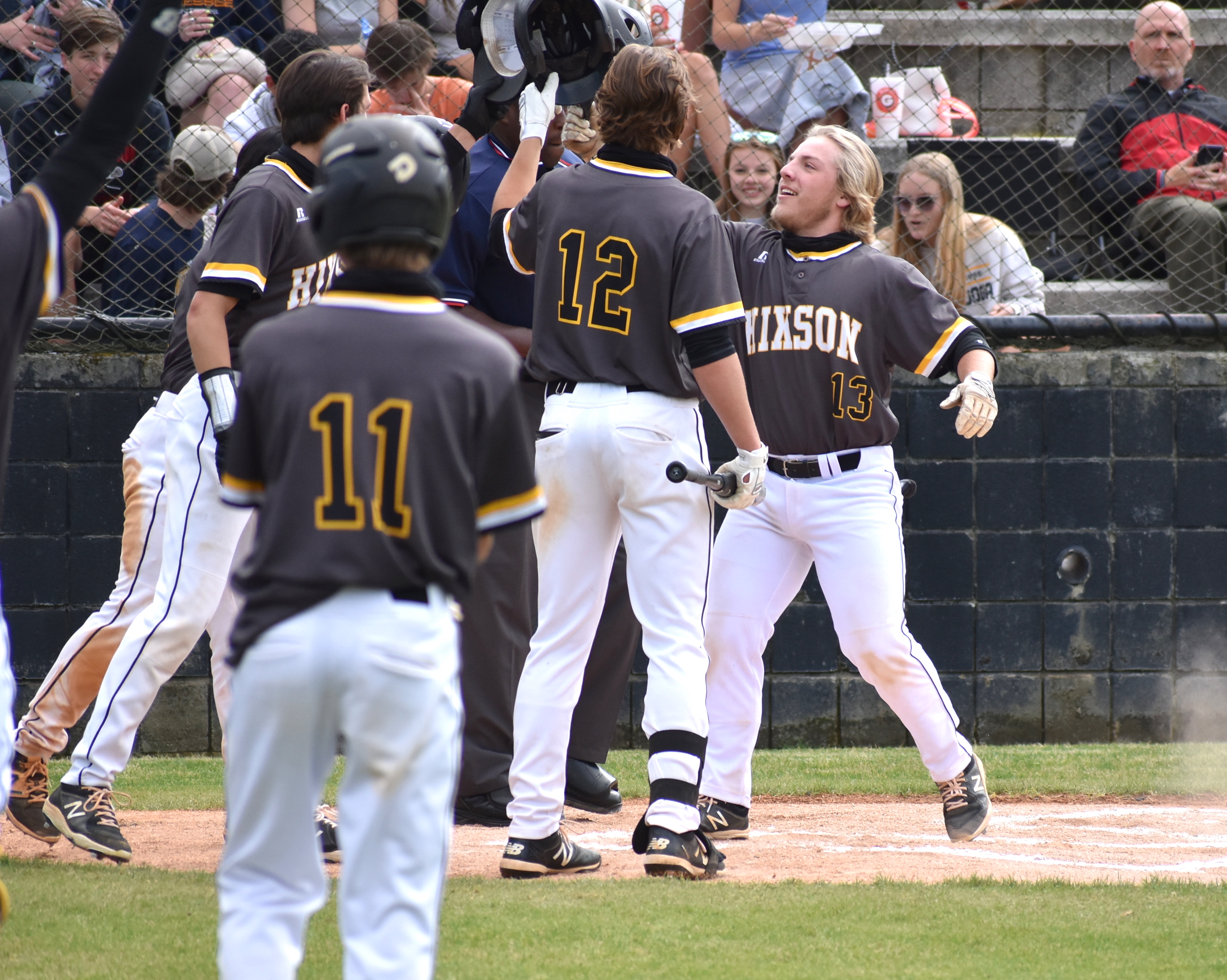 Staff photo by Patrick MacCoon / Hixson's Kane Johnson celebrates with teammates after his home run Wednesday in the District 6-AA championship round against Signal Mountain.