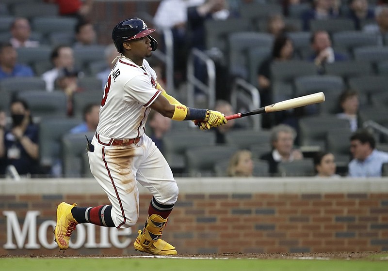 Atlanta Braves' Ronald Acuna Jr. swings for a home run off Toronto Blue Jays pitcher Robbie Ray in the third inning of a baseball game Tuesday, May 11, 2021, in Atlanta. (AP Photo/Ben Margot)