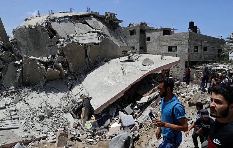 People inspect the rubble of a destroyed residential building which was hit by Israeli airstrikes, in Gaza City, Wednesday, May 12, 2021. (AP Photo/Adel Hana)


