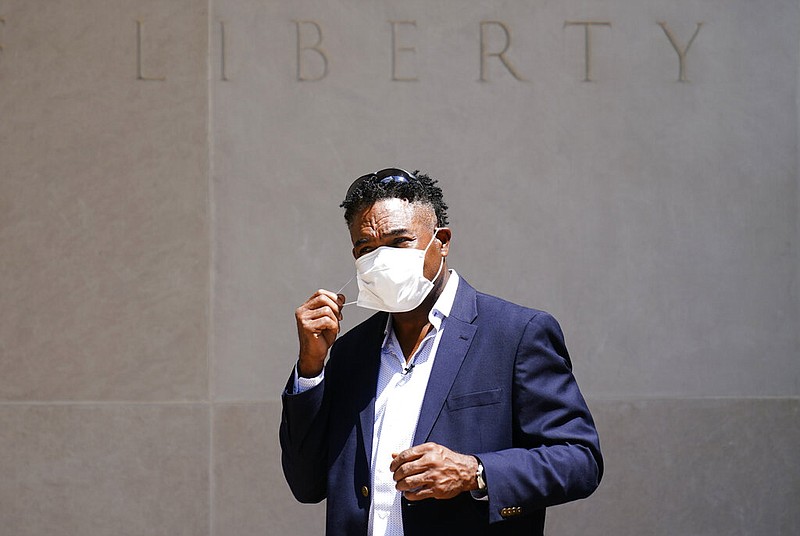 Former NFL player Ken Jenkins exits the building after delivering tens of thousands of petitions demanding equal treatment for everyone involved in the settlement of concussion claims against the NFL, to the federal courthouse in Philadelphia, Friday, May 14, 2021. (AP Photo/Matt Rourke)
