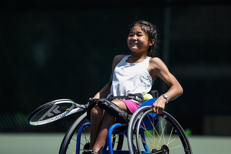Staff photo by Troy Stolt / Lucy Heald, 11, smiles as she practices tennis Thursday at Lookout Mountain Club.
