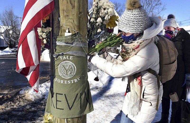 FILE — In this Feb. 8, 2021 file photo, Yale postdoctoral students Maria Kochugaeva, left, and Elvira Mulyukova leave flowers at a memorial for Yale School of the Environment grad student Kevin Jiang, near where he was killed. (Arnold Gold/Hearst Connecticut Media via AP, File)


