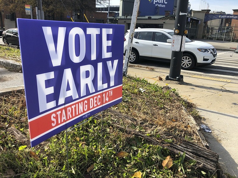 FILE - In this Dec. 11, 2020 file photo, a sign in an Atlanta neighborhood urges people to vote early in Georgia's two U.S. Senate races. (AP Photo/Jeff Amy, File)


