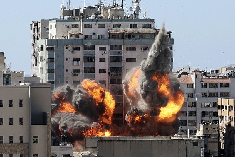 A ball of fire erupts from a building housing various international media, including The Associated Press, after an Israeli airstrike on Saturday, May 15, 2021 in Gaza City. The attack came roughly an hour after the Israeli military ordered people to evacuate the building, which also housed Al-Jazeera and a number of offices and apartments. There was no immediate explanation for why the building was targeted. (Mahmud Hams /Pool Photo via AP)

