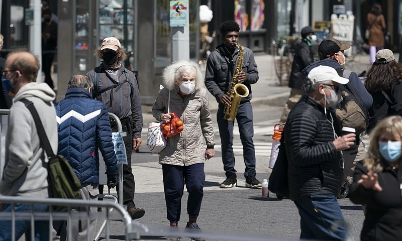 People walk on the street, Monday, April 26, 2021 in New York. The once-a-decade head count of the United States shows where the population grew during the past 10 years and where it shrank. New York will lose one seat in Congress as a result of national population shifts, according to census data released Monday. (AP Photo/Mark Lennihan)