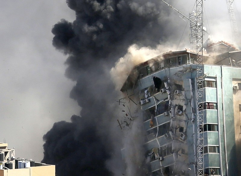 The building housing the offices of The Associated Press and other media in Gaza City collapses after it was hit by an Israeli airstrike Saturday, May 15, 2021. The attack came roughly an hour after the Israeli military warned people to evacuate the building, which also housed Al-Jazeera and a number of offices and apartments. There was no immediate explanation for why the building was targeted. (AP Photo/Hatem Moussa)