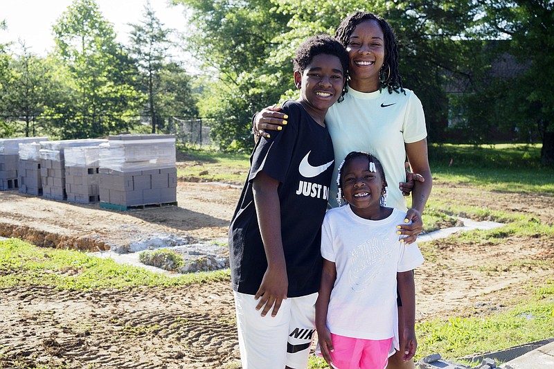 Staff photo by C.B. Schmelter / Tanieshia Looney poses with her children, A'Nieshia Jones, 6, and Anthony Fullilove, 12, at the site of their future home on Saturday, May 15, 2021 in Chattanooga, Tenn.