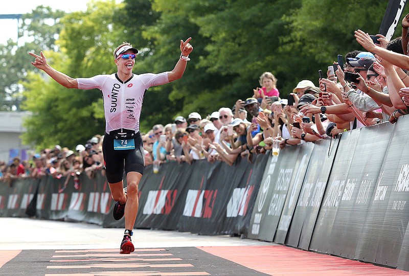 Staff file photo / Fans cheer on triathlete Sam Long as he runs to the finish line to win the Sunbelt Bakery Ironman 70.3 Chattanooga on May 19, 2019, in Chattanooga, Tennessee.