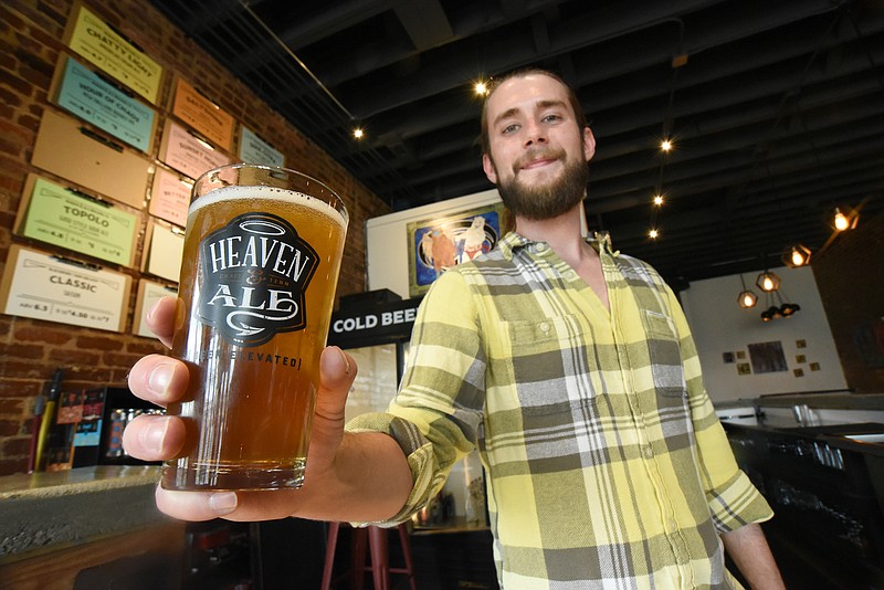 Staff Photo by Matt Hamilton / General manager Ty Brown serves up a beer at Heaven & Ale Brewing Co. on East Main Street.