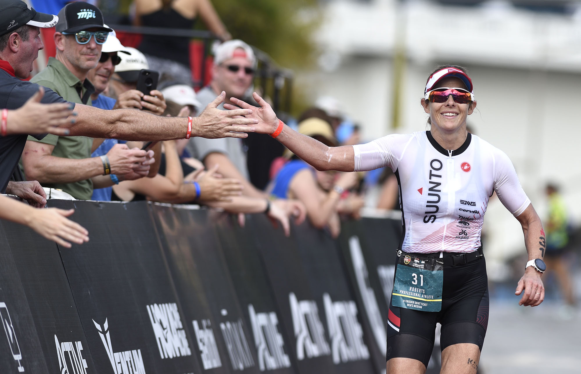 Staff file photo by Robin Rudd / Women's second place finisher Lisa Roberts slaps hands with the spectators as she finishes the race during the Little Debbie Ironman Chattanooga that took place under hot conditions on September 29, 2019.