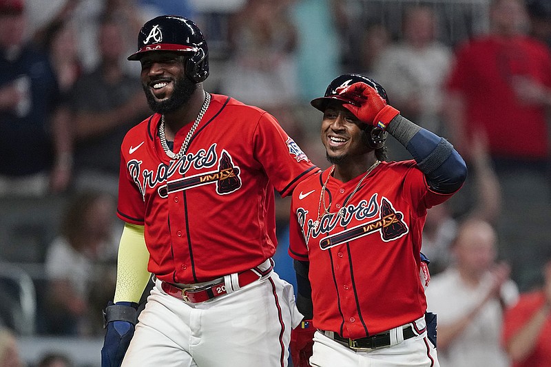 AP photo by John Bazemore / Ozzie Albies, right, walks to the dugout with Marcell Ozuna after hitting a home run in the fifth inning of the Atlanta Braves' home game against the Pittsburgh Pirates on Friday night.