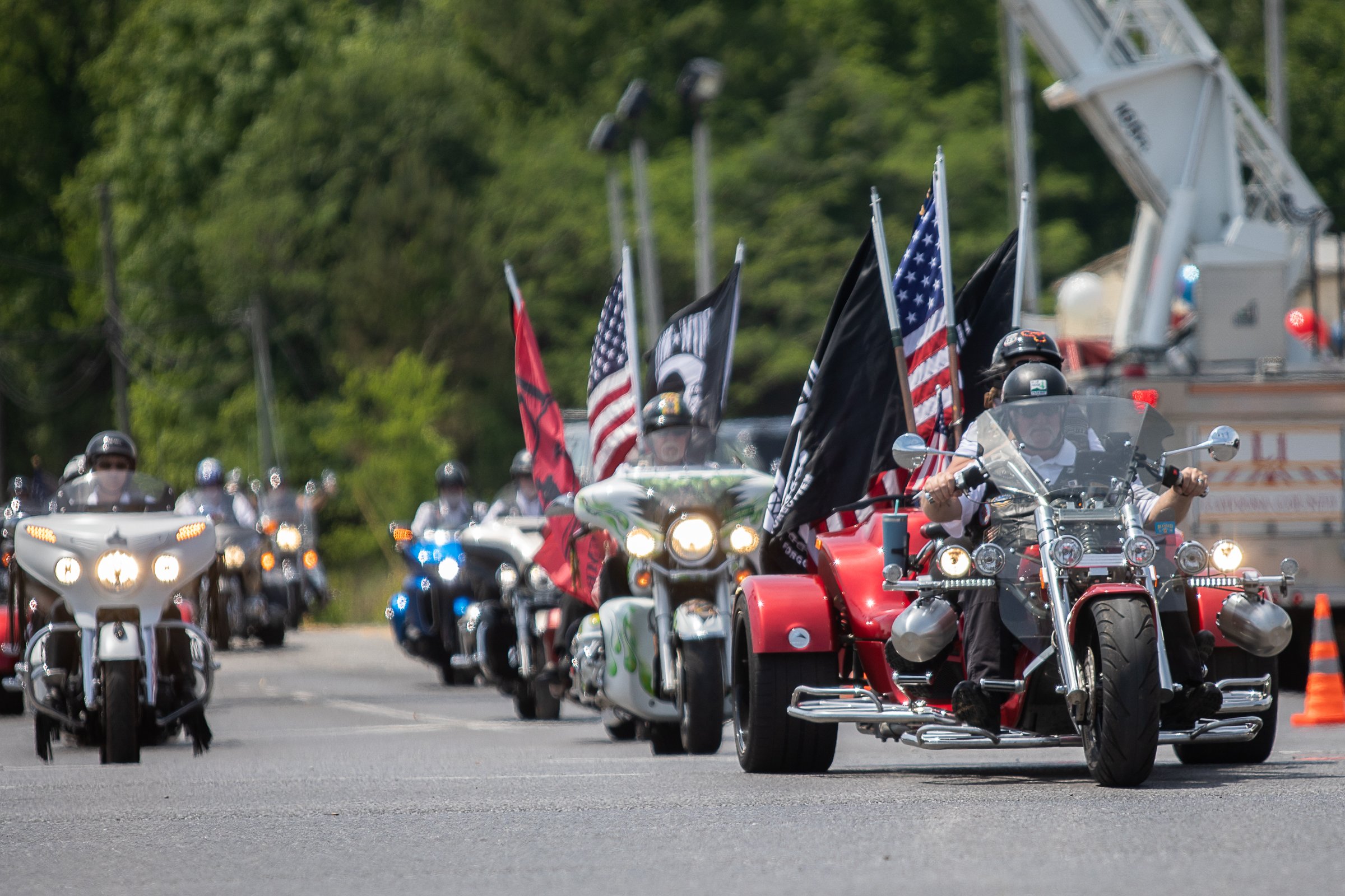 Staff photo by Troy Stolt / A funeral procession for Army Cpl. Henry L. Helms, who was killed in action at The Battle of Chosin Reservoir during the Korean War drives down Lafayette Street towards Anderson Memorial Gardens on Saturday, May 22, 2021 in Ringgold, Georgia. Helms, who was ruled missing in action for seven decades, was identified by his family and given full honors with funeral rites after a 2018 meeting between North Korean Chairman Kim Jong Un and former President Donald Trump, in which an agreement was struck to repatriate remains of Americans collected from the Korean War.