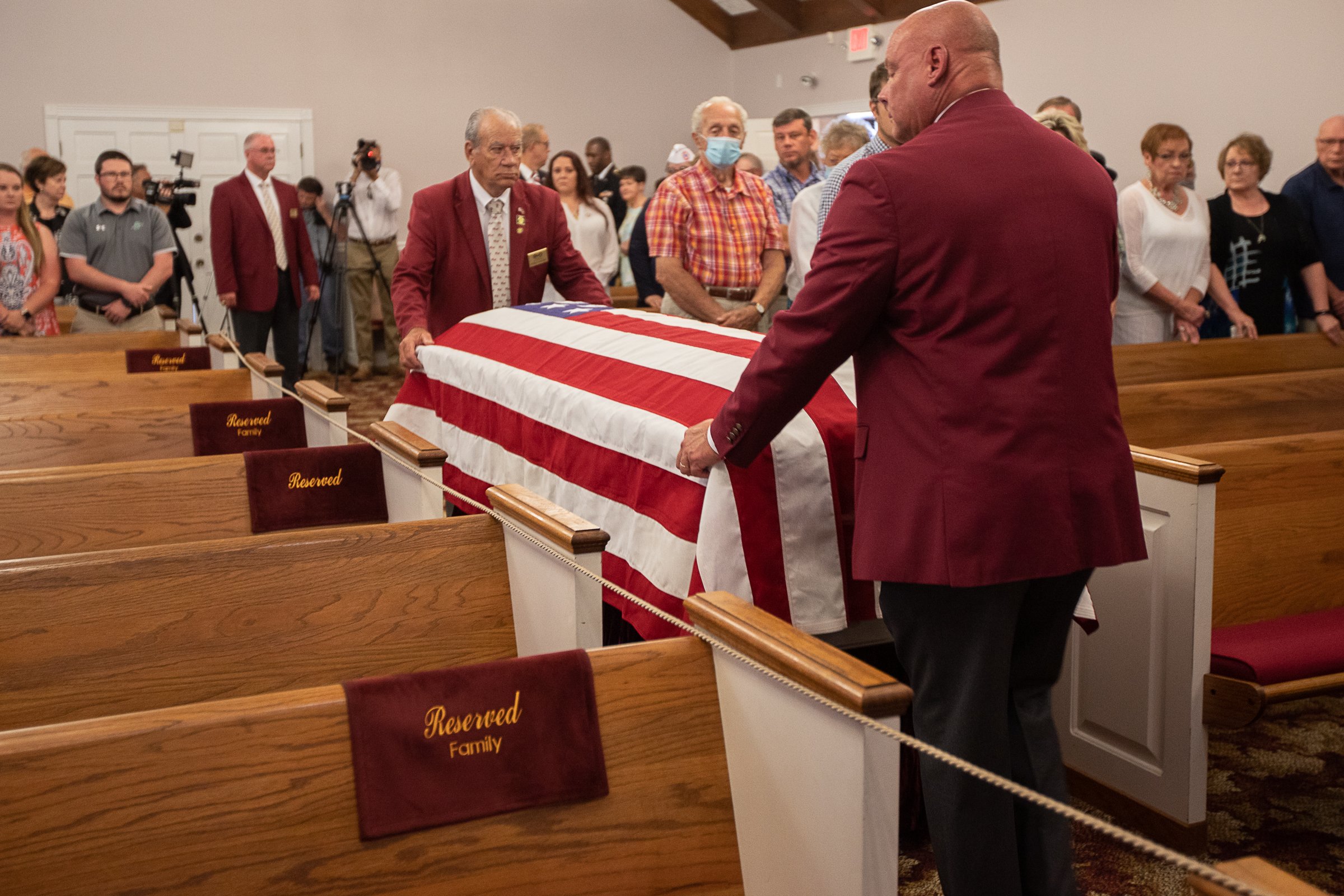 Staff photo by Troy Stolt / The remains of Army Cpl. Henry L. Helms, who was killed in action at The Battle of Chosin Reservoir during the Korean War are brought into the chapel at Wilson Funeral Home during a memorial service in his honor on Saturday, May 22, 2021 in Ringgold, Georgia. Helms, who was ruled missing in action for seven decades, was identified by his family and given full honors with funeral rites after a 2018 meeting between North Korean Chairman Kim Jong Un and former President Donald Trump, in which an agreement was struck to repatriate remains of Americans collected from the Korean War.