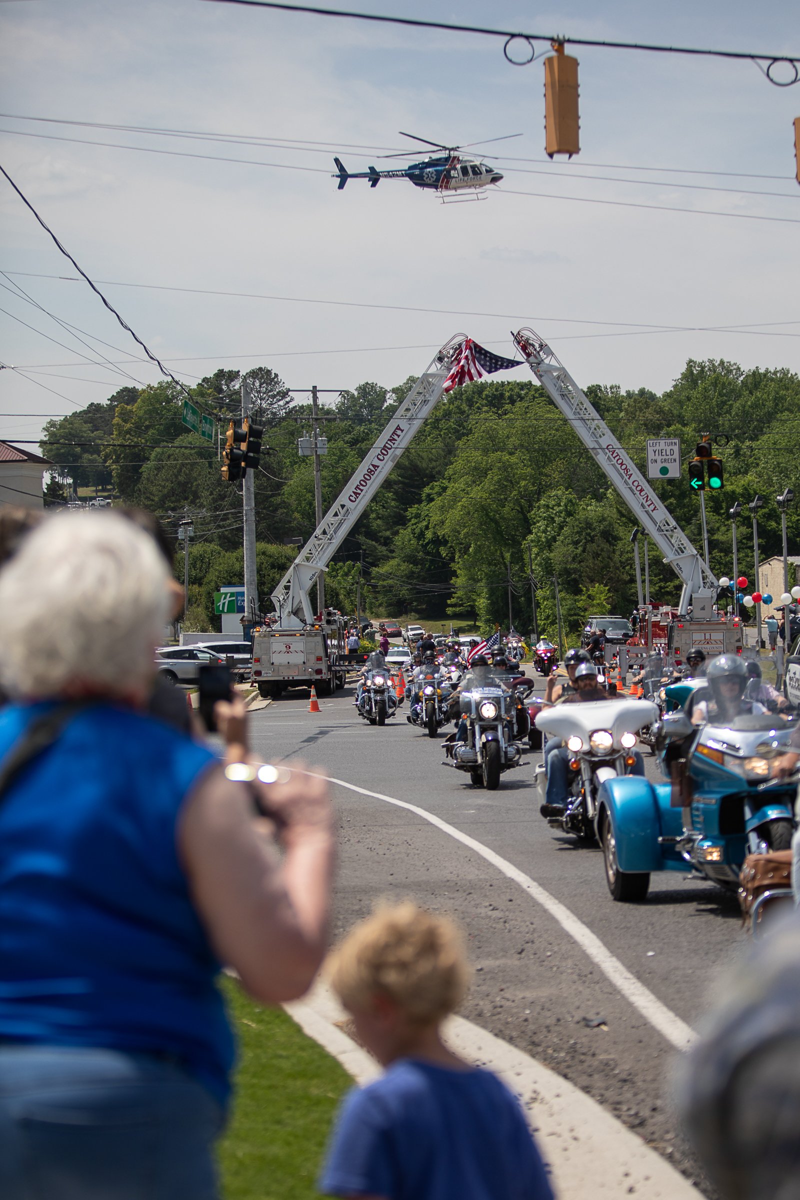 Staff photo by Troy Stolt / A funeral procession for Army Cpl. Henry L. Helms, who was killed in action at The Battle of Chosin Reservoir during the Korean War drives down Lafayette Street towards Anderson Memorial Gardens on Saturday, May 22, 2021 in Ringgold, Georgia. Helms, who was ruled missing in action for seven decades, was identified by his family and given full honors with funeral rites after a 2018 meeting between North Korean Chairman Kim Jong Un and former President Donald Trump, in which an agreement was struck to repatriate remains of Americans collected from the Korean War.