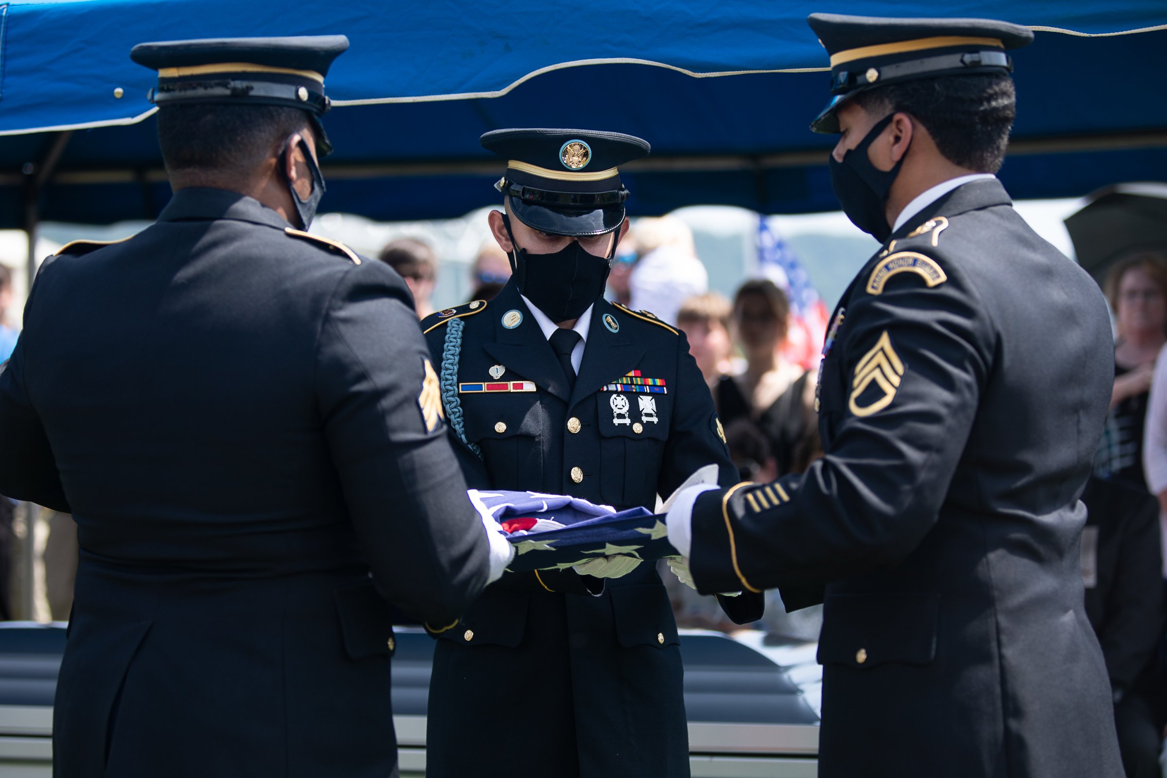 Staff photo by Troy Stolt / Members of the US Army Funeral Detail fold a flag for Army Cpl. Henry L. Helms, who was killed in action at The Battle of Chosin Reservoir during the Korean War during his funeral at Anderson Memorial Gardens on Saturday, May 22, 2021 in Ringgold, Georgia. Helms, who was ruled missing in action for seven decades, was identified by his family and given full honors with funeral rites after a 2018 meeting between North Korean Chairman Kim Jong Un and former President Donald Trump, in which an agreement was struck to repatriate remains of Americans collected from the Korean War.