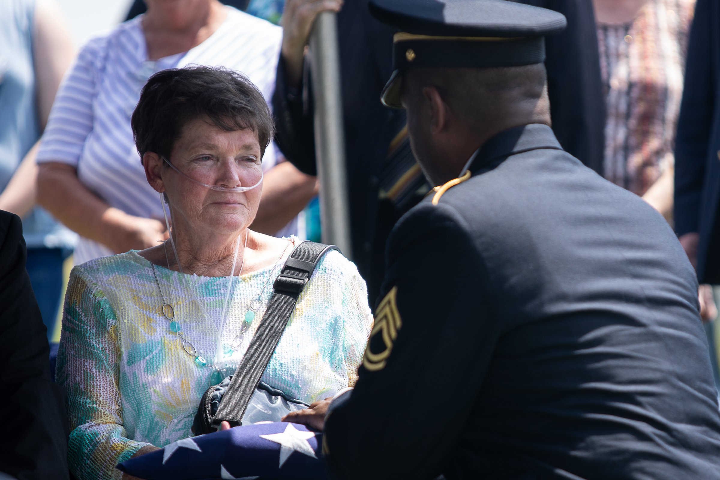 Staff photo by Troy Stolt / Evelyn Snyder, sister of the late Army Cpl. Henry L. Helms, is presented with his flag by Sgt. First Class Kentrate Wedge during a funeral in her brother's honor at Anderson Memorial Gardens on Saturday, May 22, 2021 in Ringgold, Georgia. Helms, who was ruled missing in action for seven decades, was identified by his family and given full honors with funeral rites after a 2018 meeting between North Korean Chairman Kim Jong Un and former President Donald Trump, in which an agreement was struck to repatriate remains of Americans collected from the Korean War.